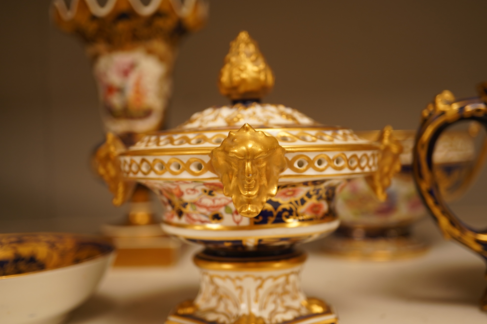 A collection of Royal Crown Derby, to include a two handled bowl, a fluted pedestal vase, saucer with landscape central cartouche etc (5). Vase 19cm high.